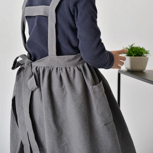 Kids pinafore apron in charcoal, linen and cotton fabric, tie back and roomy pockets in front